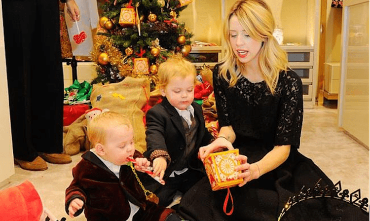 Woman opening gifts with her two children