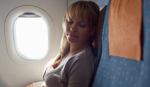 woman sleeping in plane