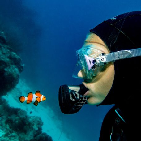 person in black and white goggles and goggles under water