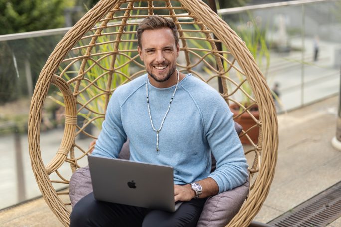 Max Gloeckner sitting and smiling, increase ROI 