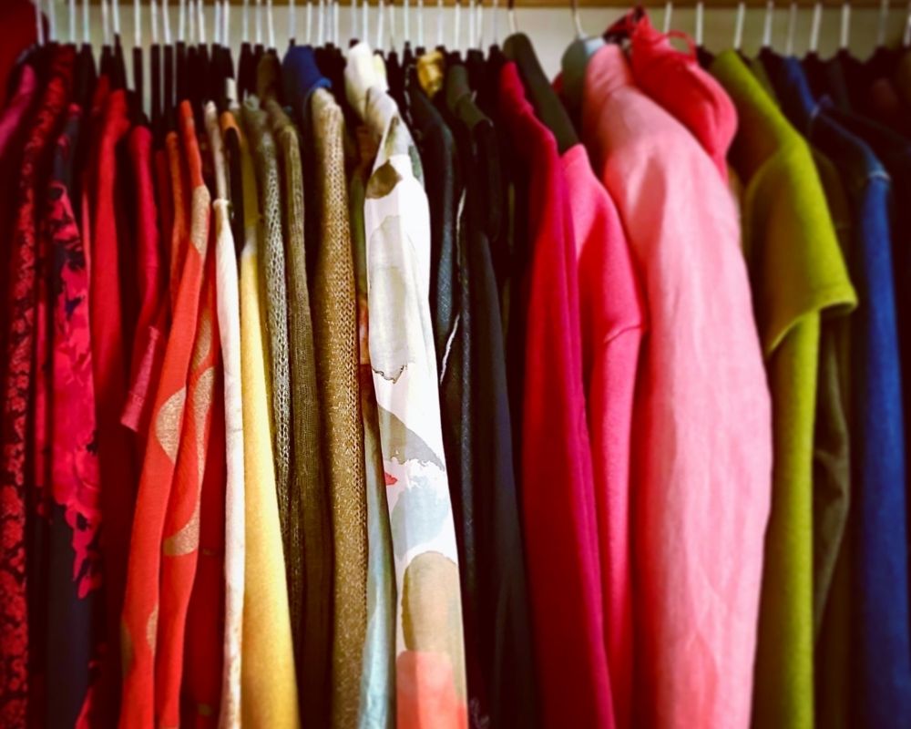 Warm toned clothes hanging on a rack