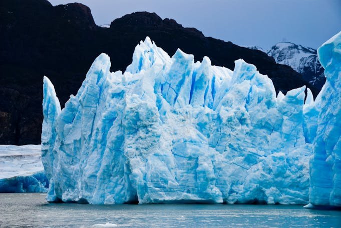 A stunning view of a towering blue glacier in the Antarctic region, showcasing natural beauty.